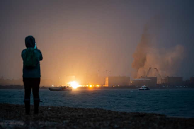 A person takes photos as Fawley Power Station chimney is demolished today Picture:  Finnbarr Webster/Getty Images