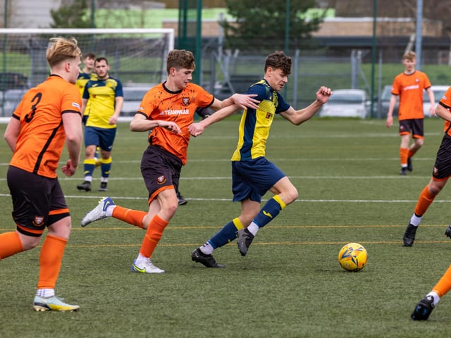 Action from the 2-2 draw between the under-18s of Moneyfields (blue/yellow kit) and AFC Portchester (orange/black kit). Picture: Mike Cooter