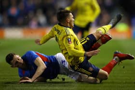Arsenal's Lucas Torreira is tackled by Pompey defender James Bolton.  Picture: Richard Heathcote/Getty Images