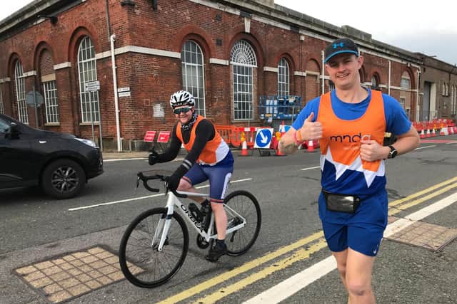 Able Rate Eddy Eggleton, right, is running seven marathons in seven days this week in a bid to raise money for the Motor Neurone Disease Association. He is pictured with Tom Galloway, who is cycling next to him as his support.  Photo: Royal Navy