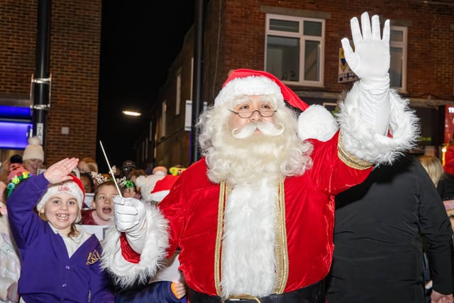 Santa Clause delighted the kids with an appearance as he turned on the light with The Elf.  Photos by Alex Shute