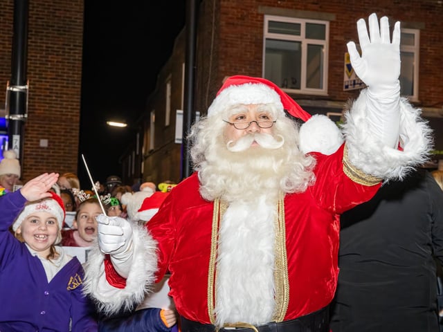 Santa Clause delighted the kids with an appearance as he turned on the light with The Elf.  Photos by Alex Shute