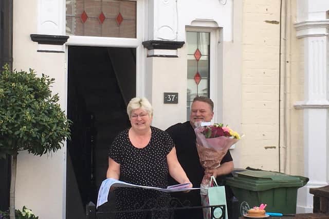 Zoe and Tony Duke outside their home as neighbours sing Happy Birthday to Zoe.