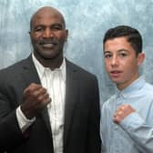 Boxing brothers Mikey McKinson, left, and Lucas Ballingall, right, with former undisputed cruiserweight champion Evander Holyfield. Picture: Mick Young