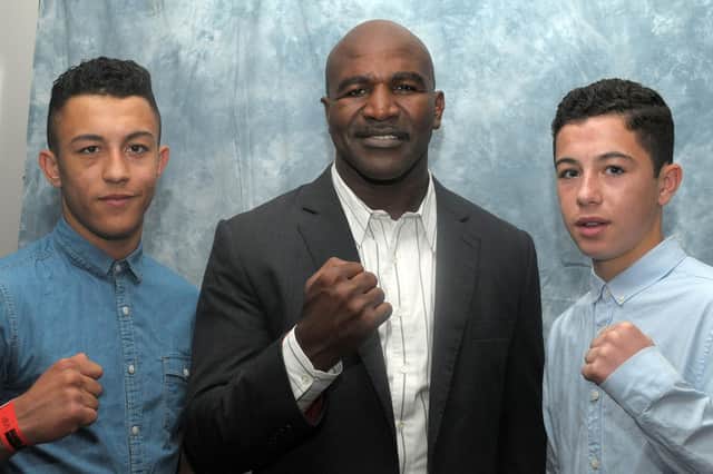 Boxing brothers Mikey McKinson, left, and Lucas Ballingall, right, with former undisputed cruiserweight champion Evander Holyfield. Picture: Mick Young