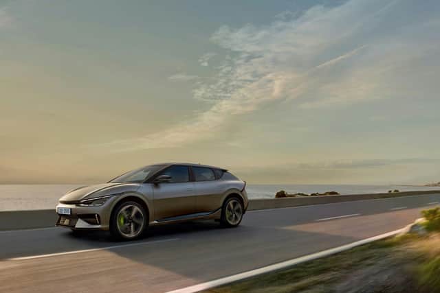 Electric vehicle driving along the coast.