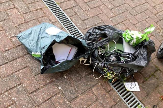 Fly tipped waste dumped by a recreation ground