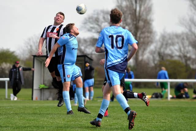Dan Clasby, left, wins this header during Hayling United's friendly win against Portchester U23. Picture: Allan Hutchings