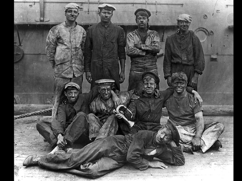 British sailors covered in coal dust after coaling ship.