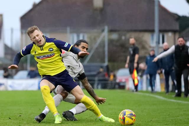 Mason Walsh is fouled by Walton Casuals captain Joshua Lelan. Picture: Chris Moorhouse