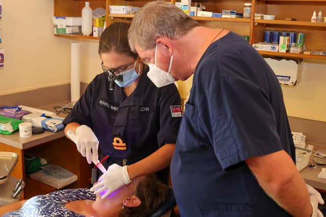 Surgeon Lieutenant Karolyn John trains local doctor, Dr Kevin Walters in dental care.