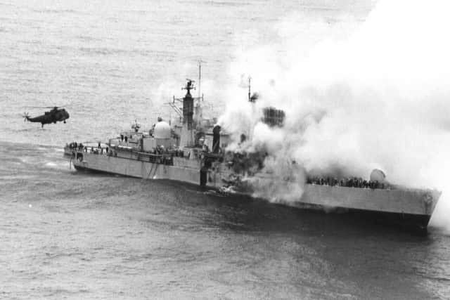 A Sea King hovers off HMS Sheffields stern during the rescue operation to recover her ships company