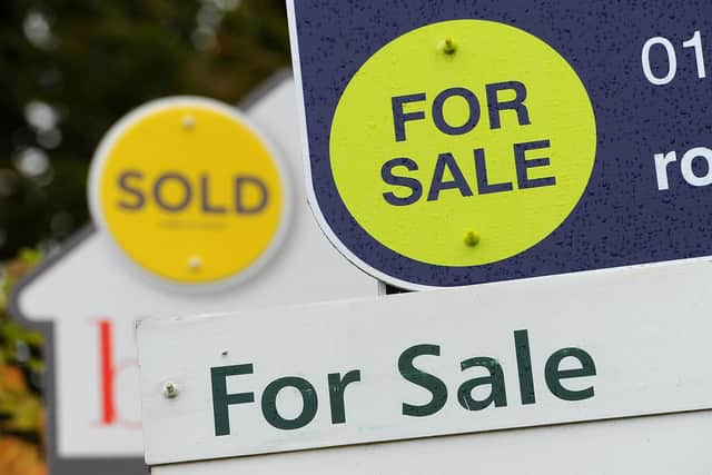 Sold and For Sale signs in the street