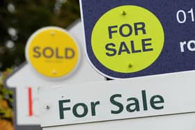 Sold and For Sale signs in the street