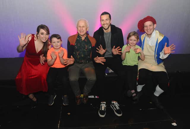Wayne Sleep, third left, and Portsmouth FC player Christian Burgess, third right, with some of Hayling Musical Society, from left, Kate Backaller, 30, George Porter, five, Phoebe Perry , six, and Paul Goldthorpe, 30 
Picture: Sarah Standing (200220-8283)