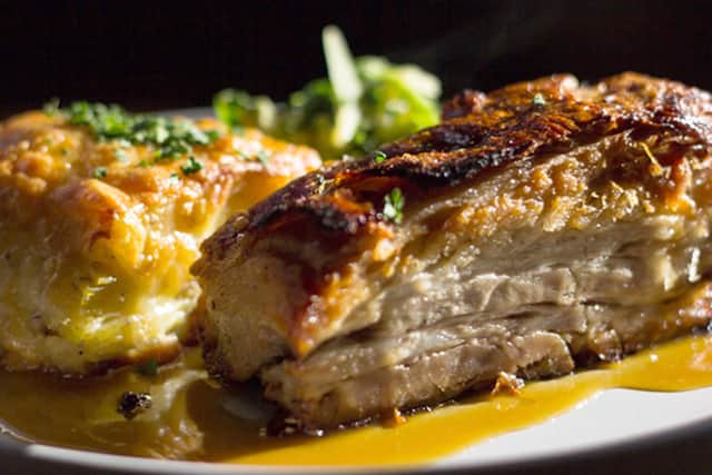 Huis's Pork belly slowly roasted in Lindemans Apple beer, served with stoemp or truffled potato dauphinoise, and seasonal vegetables, finished with apple beer and mustard reduction.