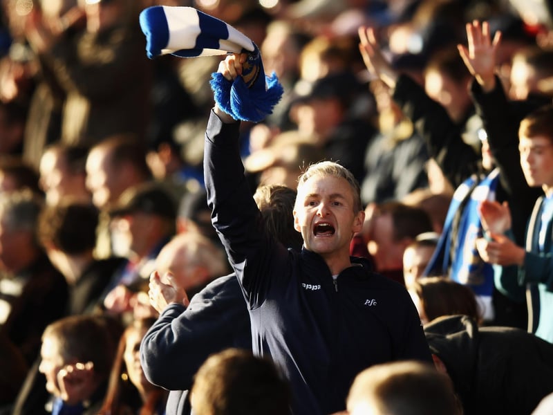 A Pompey fan waves his scarf during the visit of Middlesbrough to Fratton Park in March 2012. Photo by Bryn Lennon/Getty Images