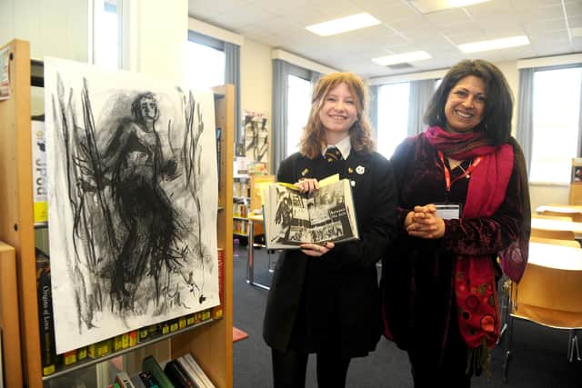 On International Women’s Day, Portsmouth Grammar School welcomed author Sita Brahmachari who took part in a variety of projects with pupils from across the school. 

Pictured is: Sophie Matheson (17) showing her artwork to author Sita Brahmachari. 

Picture: Sarah Standing (080322-522)