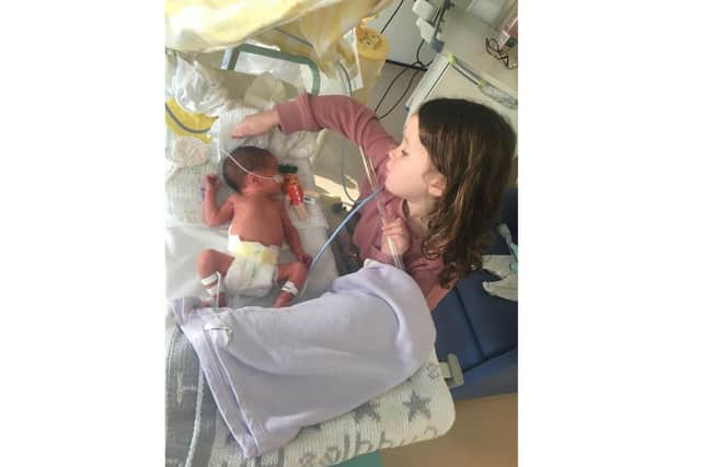 Maisy Brotherton-Smillie, 5 from Gosport, scooted 26 miles for charity Ickle Pickles which helped when her brother Brody was born seven weeks early. Pictured: Maisy with her brother Brody in hospital