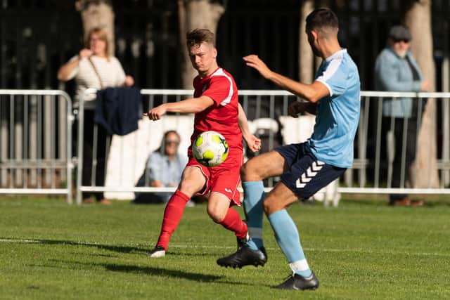 Former Baffins Milton Rovers midfielder Robbie Taw, left, on his league debut for Horndean against Poppies. Picture: Keith Woodland