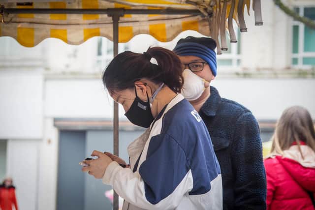 People wearing face masks in the Coronavirus outbreak in Commercial Road, Portsmouth. Pictured on March 20 before government announced a lockdown. Picture: Habibur Rahman