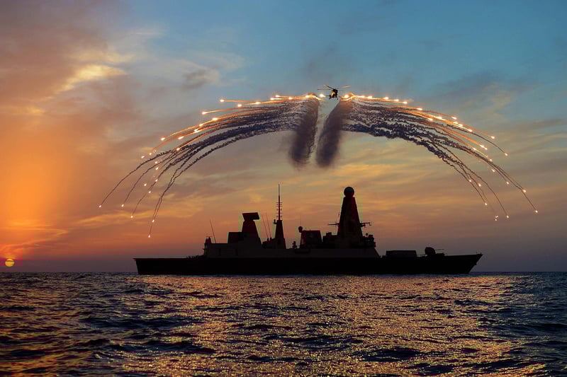 HMS Dragon's Mk8 Lynx Helicopter conducted day into night flying. As part of the sortie it fired all of it's countermeasure flares as the sunset over the ship on the 19th Septemember 2013.