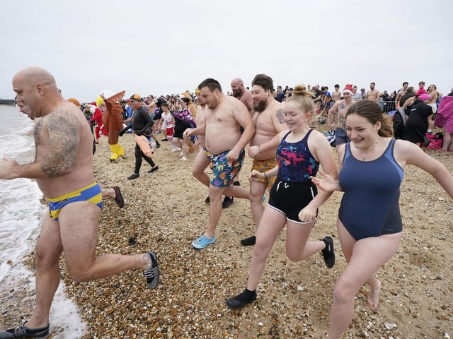 People run into the sea as they take part in the Gosport New Year's Day Dip in The Solent at Stokes Bay, Gosport, Hampshire, to raise money for Gosport and Fareham Inshore Rescue Service.