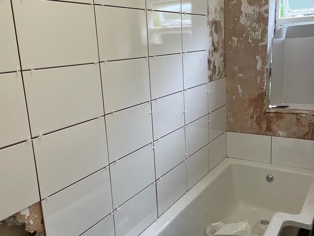 Works undertaken to a bathroom. Bradley Willis-Chambers informed the complainant that the wall was rotten and needed to come down. Instead, Willis-Chambers tiled over the wall in attempt to defraud the customer.