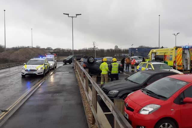 Emergency services deal with a flipped Toyota Yaris in the car park for Lidl and McDonald's in Elettra Avenue, Waterlooville. Picture: Neil Fatkin