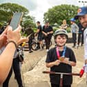 Declan Brooks allows fan Cobie Wenyon-Chambers, 10, to pose with his Olympic bronze medal for a photo at Southsea skatepark at the weekend. Cobie has been inspired by Declan's Tokyo achievements. Picture: Mike Cooter