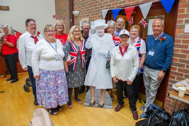 Staff and comittee members with a cardboard cutout of the Queen 
Picture: Habibur Rahman