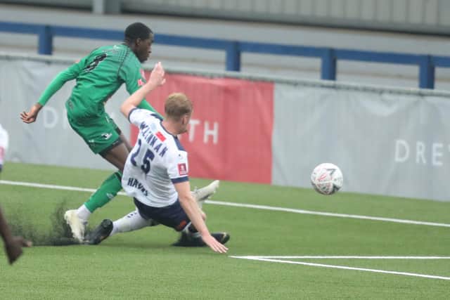 Cray's Ade Adeyemo fires over under pressure from George Mclennan. Photo by Dave Haines