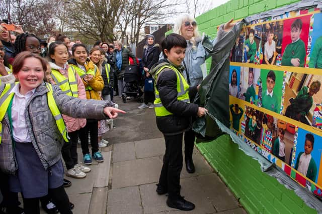 Azher, 10, unveils the first art work as other pupils watch. Picture: Habibur Rahman