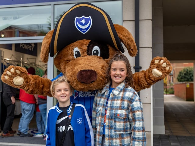 Pompey mascot Nelson with Arlo Newlyn (7) and sister Ada Newlyn (9) at the new Pompey Store in Gunwharf Quays. Picture: Mike Cooter (011124)