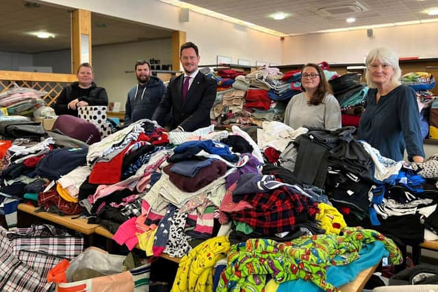 Stephen Morgan, Portsmouth South MP, pictured centre, with volunteers from Ems4Afghan at their collection hub in Fareham as they sift through donated clothes for refugees.