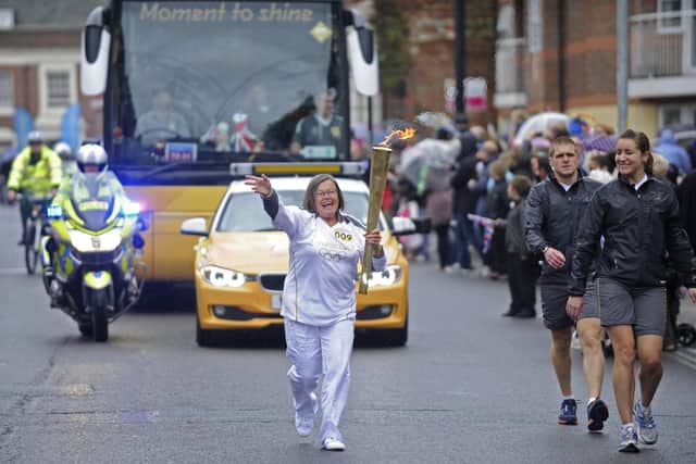Bronwin Carter carrying the the Olympic flame along Kingston Road during the Olympic Torch relay in 2012
Picture: Ian Hargreaves  (122403-19)