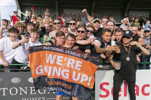 Alfie Rutherford, front left, and Dorking Wanderers manager and chairman Marc White, front right, are mobbed by club supporters after promotion is achieved. Picture: Steve O'Sullivan Photography