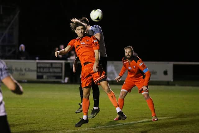 Scott Jones rises for a header against Pagham last night. Picture by Nathan Lipsham