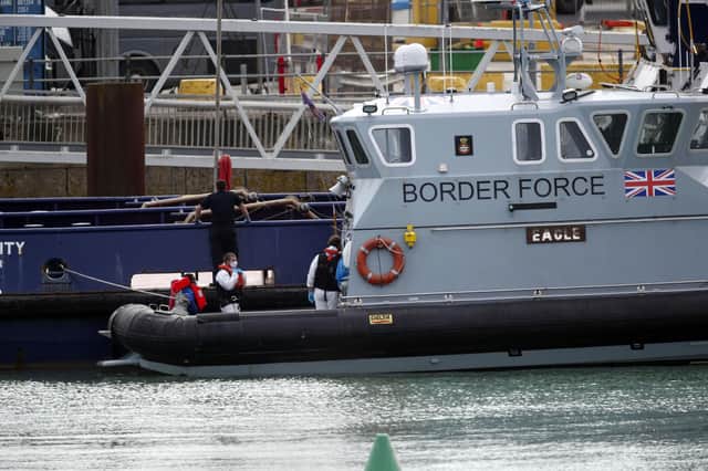 A group of people thought to be migrants are brought into Dover, Kent, by Border Force officers following a small boat incident in the Channel. Picture date: Tuesday September 1, 2020. Steve Parsons/PA Wire