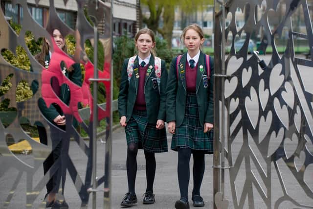 Friends Dulcie Davis, 12, and Evie Hext, 13, walking out of the school gates at St Edmond's Catholic School. Pupils don't know when the school will fully reopen.

Picture: Habibur Rahman