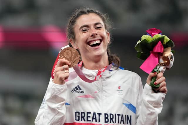 Bronze medalist Olivia Breen, a City of Portsmouth AC member, celebrates on the podium at the medal ceremony for the Women's Long Jump - T38 on day 7 of the Tokyo 2020 Paralympic Games. Photo by Christopher Jue/Getty Images.