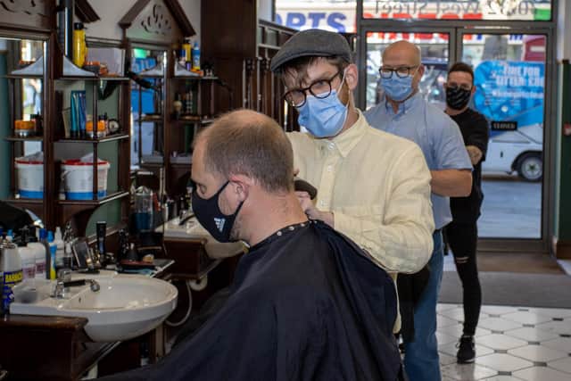 Trainee Matt at Stephen's Barbers, with Sean Haines behind and Adam Stoker. Photos by Alex Shute