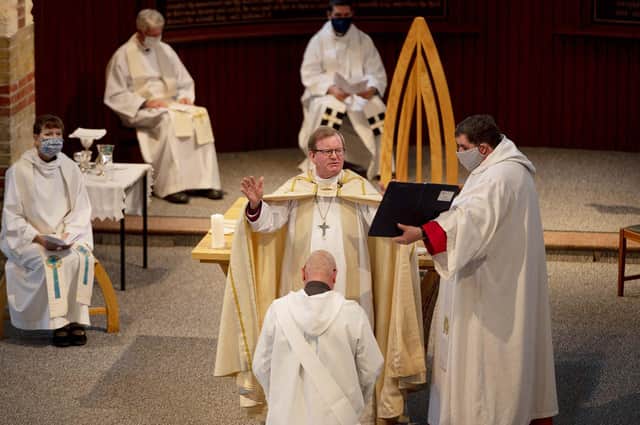 Bishop Christopher Foster and the Rev Bryan Stephenson (centre) with Archdeacon of Portsdown the Ven Jenny Rowley (left) and area dean of Portsmouth Canon Bob White (right - holding the folder), at St Luke's Church, Southsea