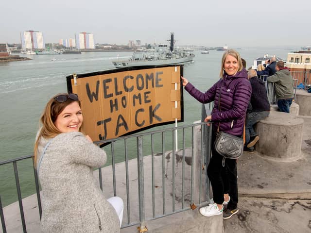 Georgia Davis and Michelle Feltham on the Round Tower, Old Portsmouth welcoming HMS Lancaster as it arrives in Portsmouth. Picture: Habibur Rahman