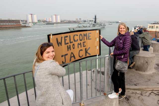 Georgia Davis and Michelle Feltham on the Round Tower, Old Portsmouth welcoming HMS Lancaster as it arrives in Portsmouth. Picture: Habibur Rahman