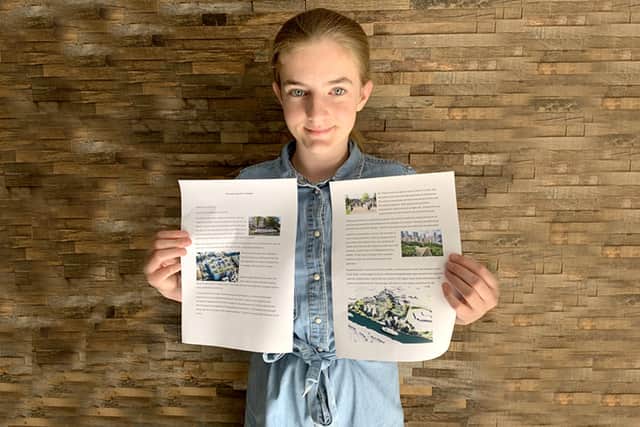 Amelie Van Gelder, 13, with the plans for her winning sustainable city design.