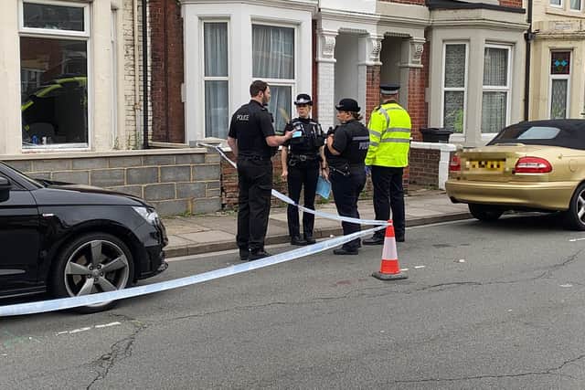 Police pictured outside a property in Alexandra Road, which has been cordoned off following a suspected robbery. Photo: Tom Cotterill