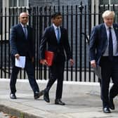 Health Secretary Sajid Javid, left, chancellor Rishi Sunak, centre, and prime minister Boris Johnson, right, walks towards the door of number 9, Downing Street ahead of a press conference on September 07, 2021 in London. Photo by Leon Neal/Getty Images