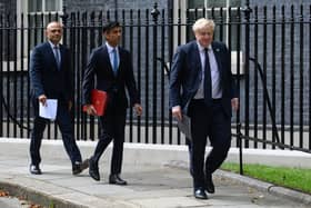 Health Secretary Sajid Javid, left, chancellor Rishi Sunak, centre, and prime minister Boris Johnson, right, walks towards the door of number 9, Downing Street ahead of a press conference on September 07, 2021 in London. Photo by Leon Neal/Getty Images