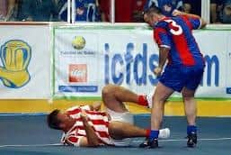 Gavin Maguire hangs over Matt Le Tissier with his fist cocked in a Masters football match.